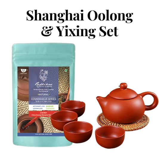 A bundle including a bag of Shanghai Oolong Tea and a set of Yixing teaware, with one visible red cup and a kettle on a mat, all against a white background.