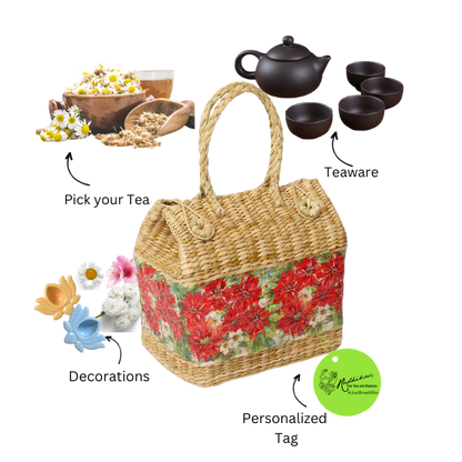 A wicker picnic basket with floral pattern, accompanied by a pottery tea set and various loose tea leaves and packaged tea bags.