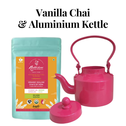 A pink and blue tea set comprising a kettle and a packaged tea product, with the brand name 'Radhikas' visible on the packaging.