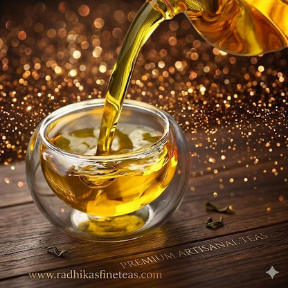 Tea being poured into a clear glass cup with a blurred background and brand name visible.