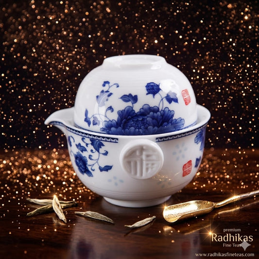 White teapot with blue floral patterns on a dark, glittery background