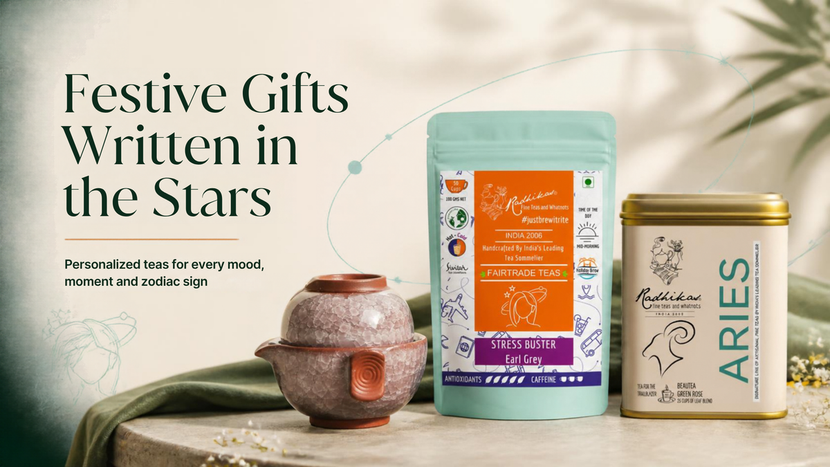 Tea gift set featuring a mint green pouch of 'Fantasy Teas' Stress Buster Green Tea and a gold tin of 'Mukeshwani Aries' tea, styled with a terracotta teapot on a stone surface against a soft, warm background with text on the left.