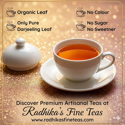 White teacup with tea on a saucer, next to a white sugar container on a gold glittery background, promoting Radhika's Fine Teas.