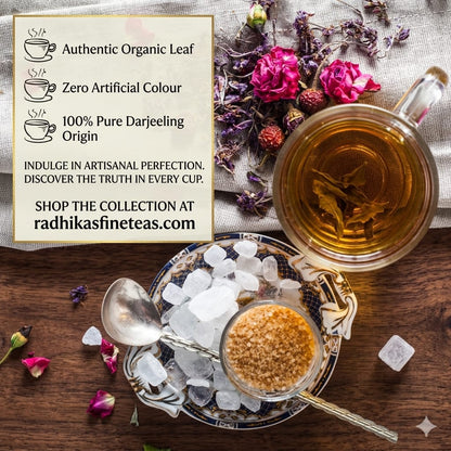 Tea cup with flowers and a bowl of sugar on a wooden surface, featuring Radhika's Fineteas branding.