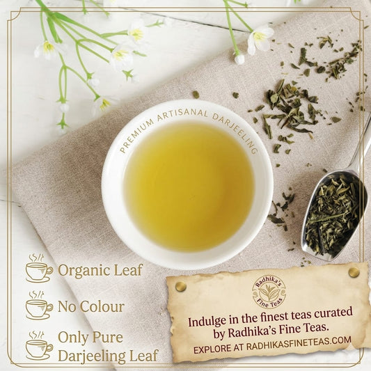 Tea cup with Darjeeling tea, tea leaves, and Radhika's Fine Teas branding.