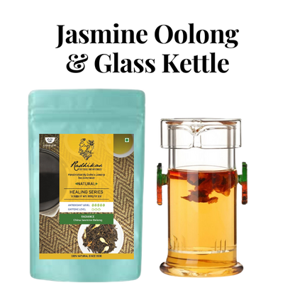 A contemporary glass kettle with a porcelain infuser next to a package of Radiance China Jasmine Oolong Tea by Radhikas Fine Teas.