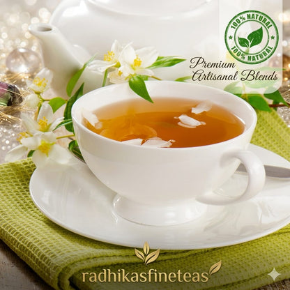 White teacup with tea and a teapot on a green cloth, featuring Radhika's Fine Teas branding.