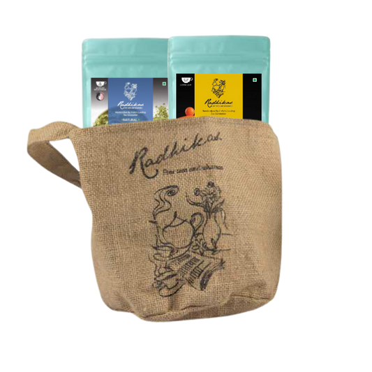Two ziplocked pouches of Radhikas Fine Teas, one with a matcha green label and the other with a butterfly blue label, placed inside a beige jute bag with an illustration of a tea pot and leaves.