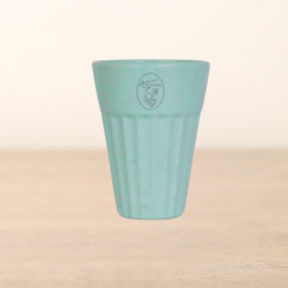 Light blue ceramic cup with a logo on a beige background