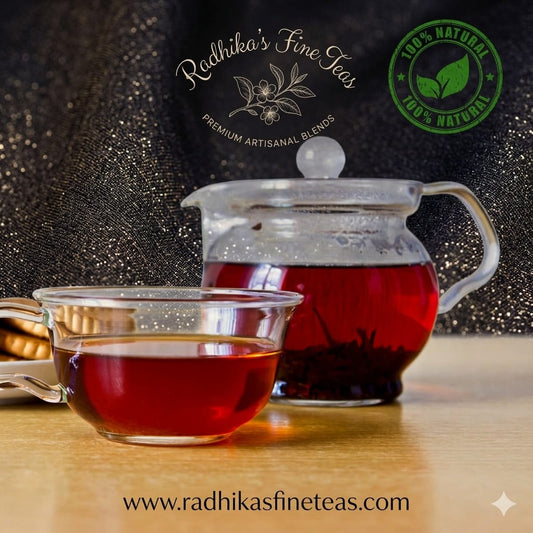 Tea cup and glass teapot with Radhika's Fine Teas branding on a dark background