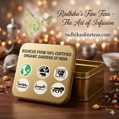Gold tea tin with Radhika's Fine Teas branding and organic certification logos on a wooden surface.