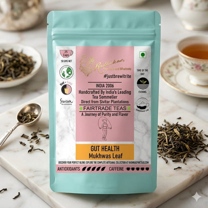 Tea package with branding and product details on a marble surface with tea leaves and a cup.