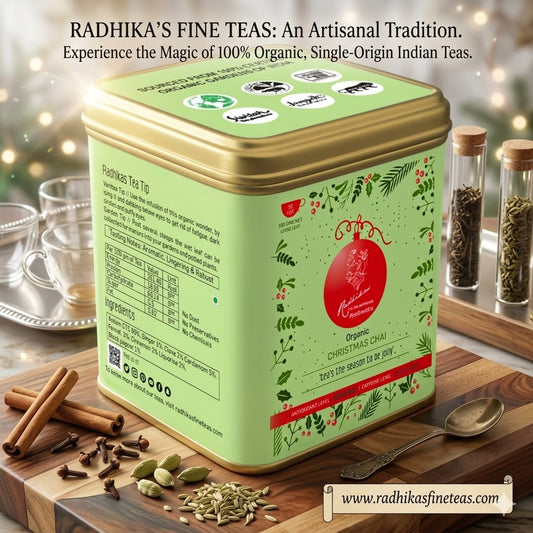 Green tea tin with decorative elements on a wooden surface with tea accessories.