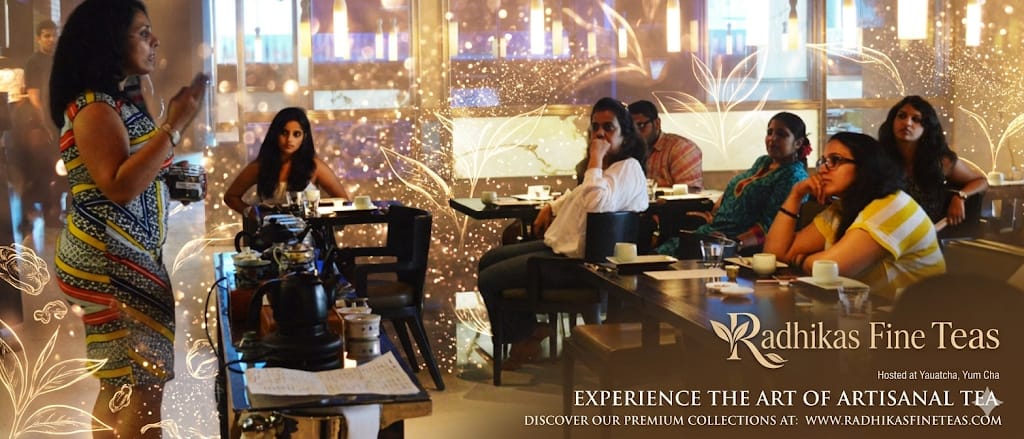 People enjoying tea at a restaurant with 'Radhika's Fine Teas' branding.