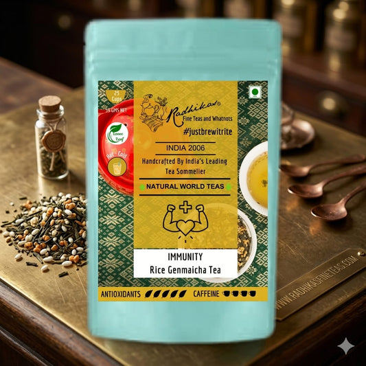 Tea package with a label on a wooden surface with tea-making items.