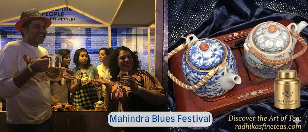 People enjoying a festive event with tea sets displayed on a table.
