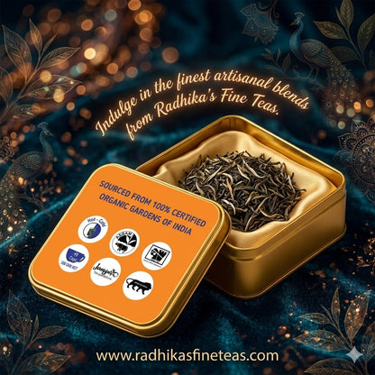 Open gold tin with tea leaves on a decorative background with text about Radhika's Fine Teas.